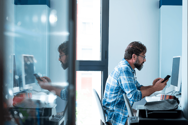 an image showing an office worker using a mobile phone